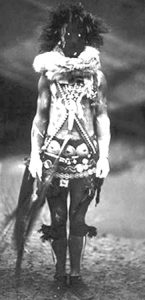 A Navajo person dressed in costume to resemble a skinwalker, or Navajo witch